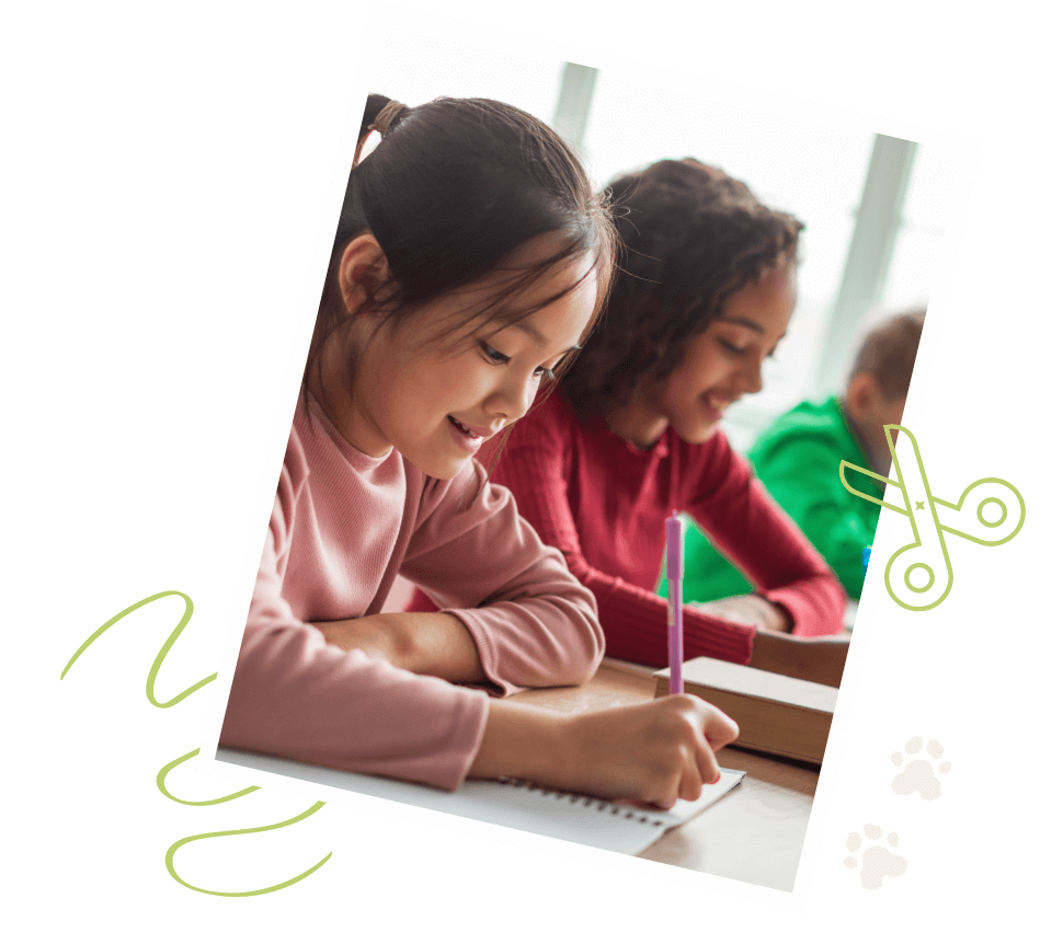 Two young girls sit at a desk, writing in notebooks and smiling, with another child in the background—capturing the joyful spirit found in new homes throughout San Antonio.
