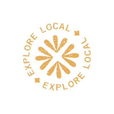 Circular stamp design with the words "Explore Local" repeated twice and a simple geometric motif in the center, all in a distressed yellow-orange color—perfect for highlighting new homes for sale in a master-planned community.