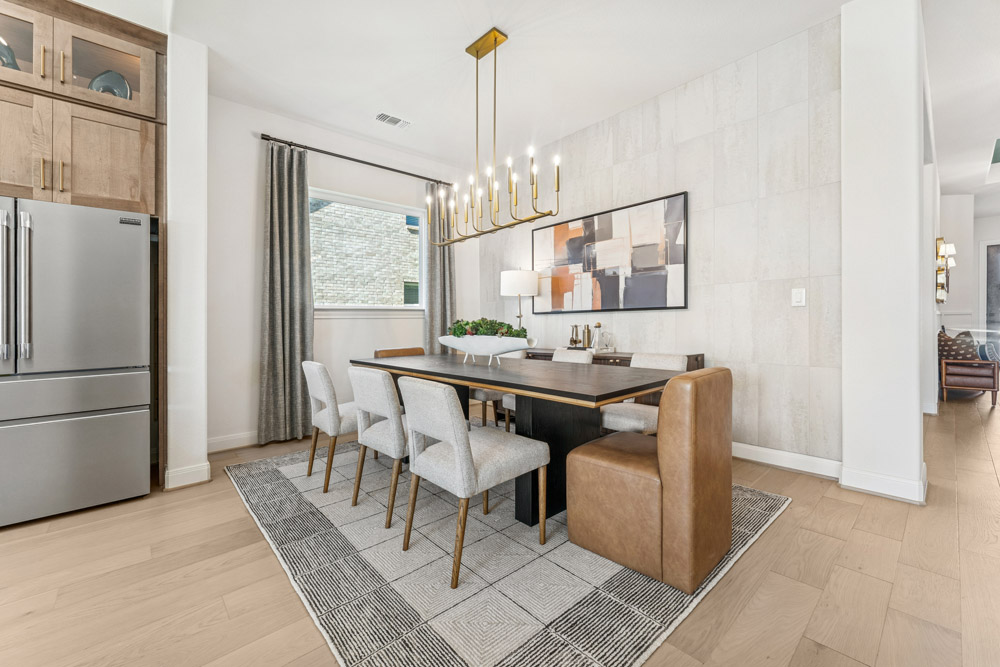 Modern dining room with six chairs, a rectangular table, and a contemporary chandelier.