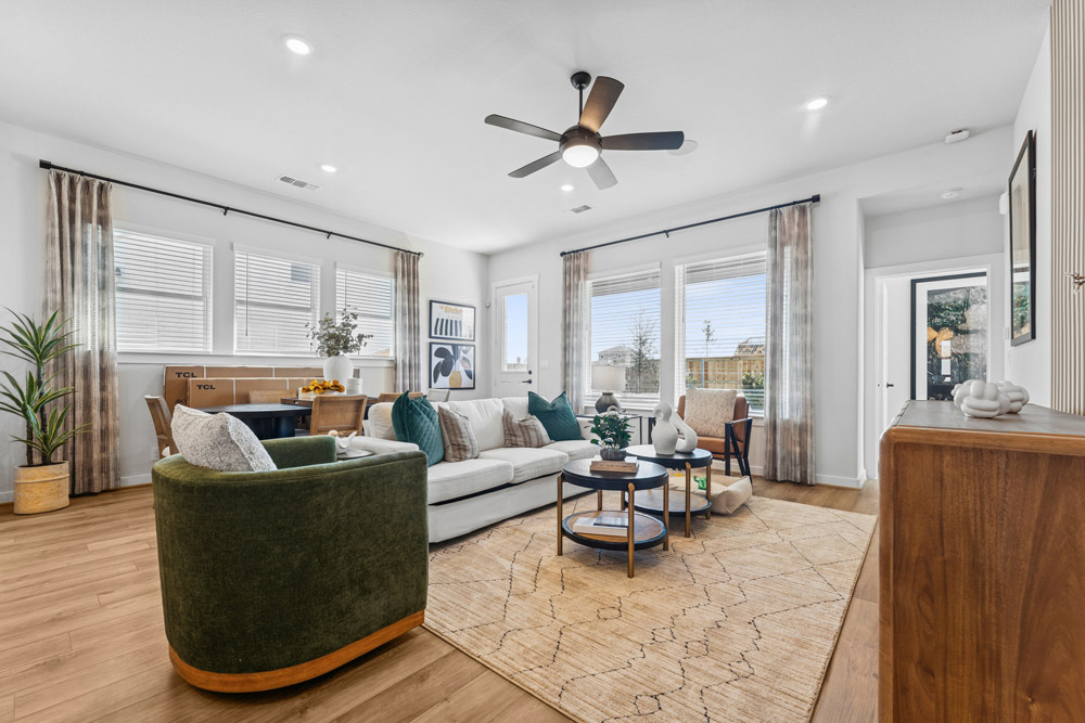 Modern living room with neutral colors, large windows, and contemporary furniture.