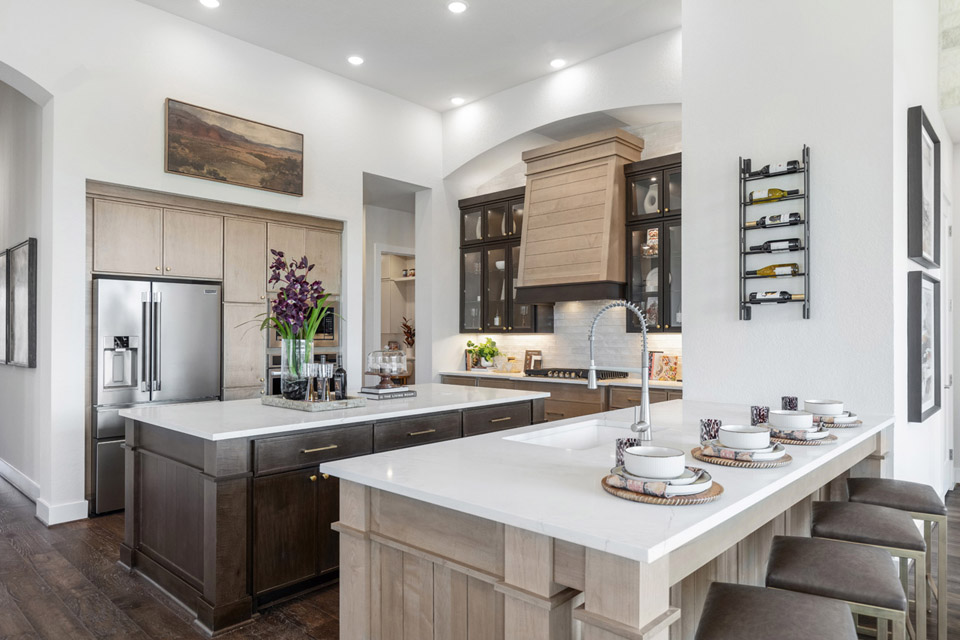 Modern kitchen with island seating, stainless steel appliances, and decorative accents.