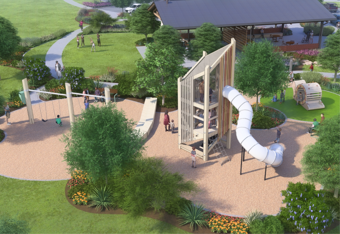 A playground with slides, swings, and people in a landscaped park with a pavilion.